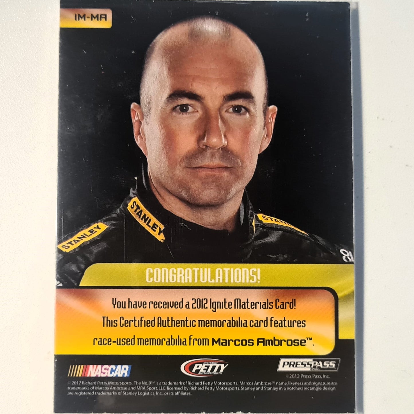 Marcos Ambrose 2012 Press pass Ignite race used materials patch IM-MA Nascar Motorsports good/very good sleeved