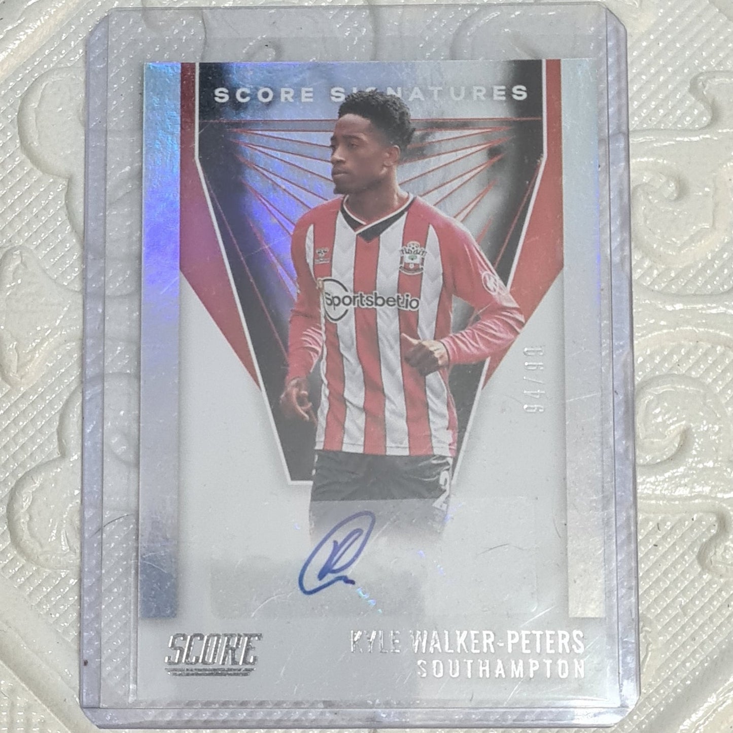 Futbol player card with red and white striped jersey on a textured background