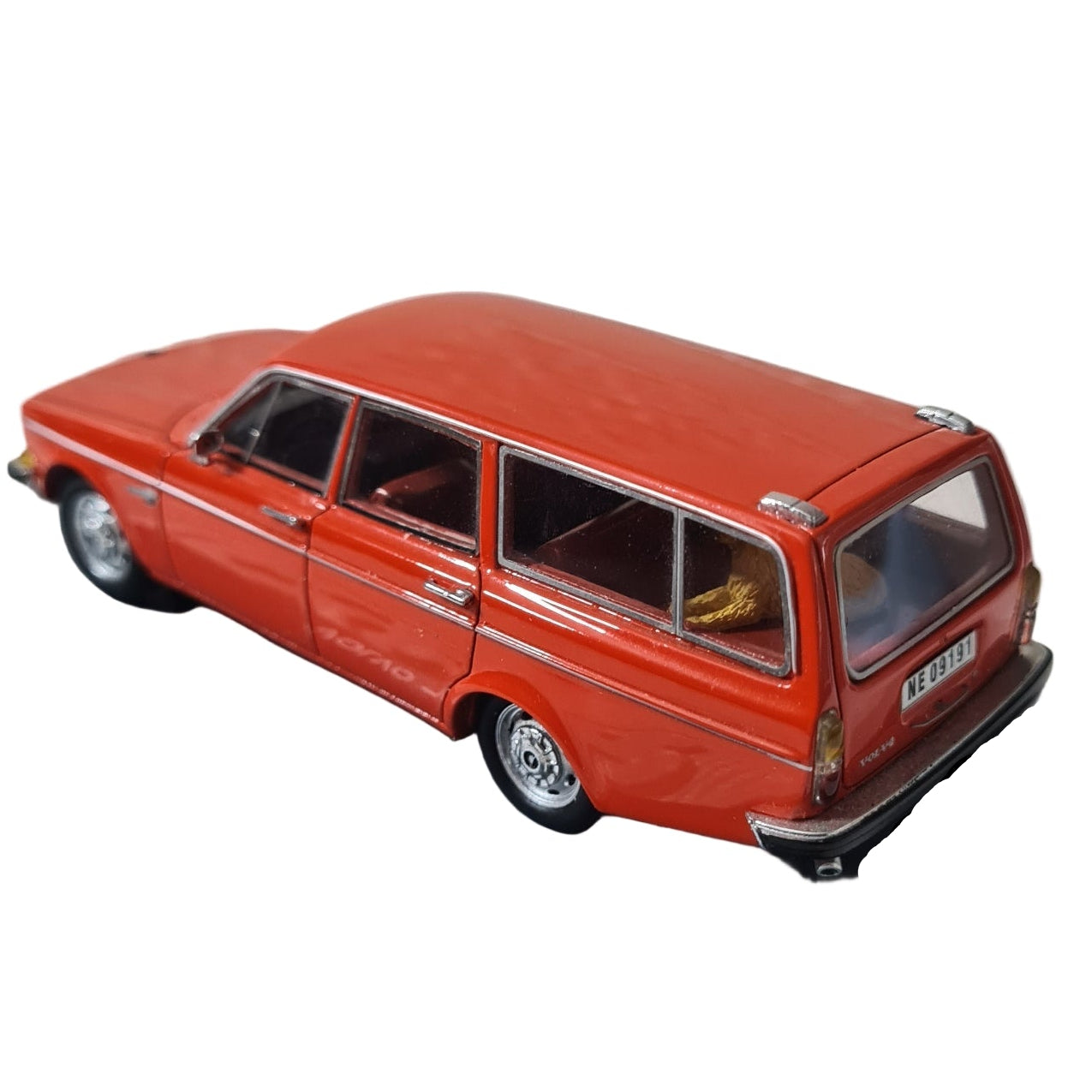 Model of a red Volvo 145 car in a black display case on a textured white background