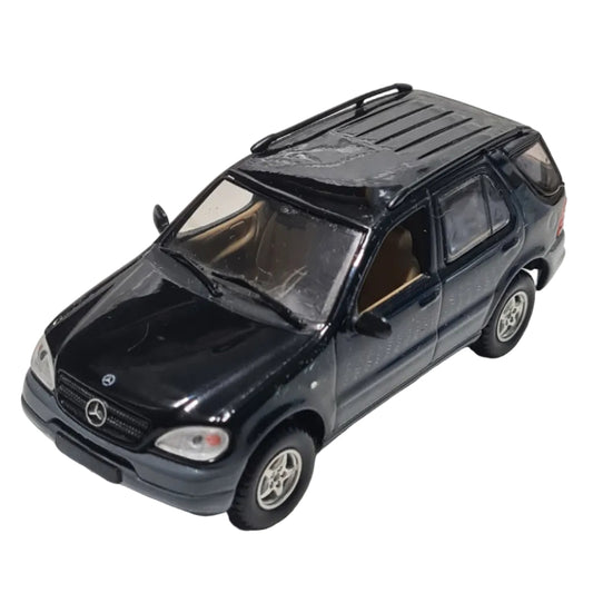 Black toy car on a textured white surface Mercedes ml320