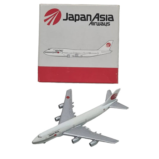 Model airplane and packaging with Japan Asia Airways logo on a textured white surface