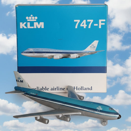A KLM 747-F model airplane displayed next to its blue and white retail box on a light-colored shelf.