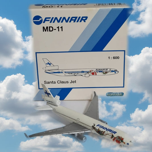 A 1:600 scale model toy of a Finnair MD-11 Santa Claus Jet, shown next to its original white and blue packaging box on a plain white background.