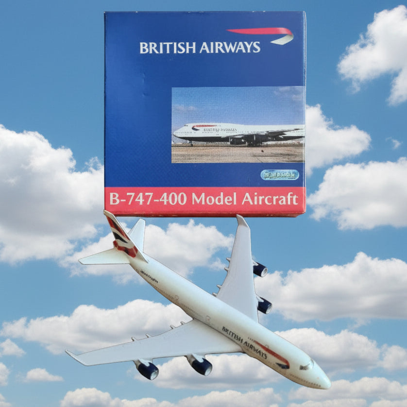 A white British Airways B-747-400 model aircraft placed next to its blue and red branded packaging box on a brown cardboard background.