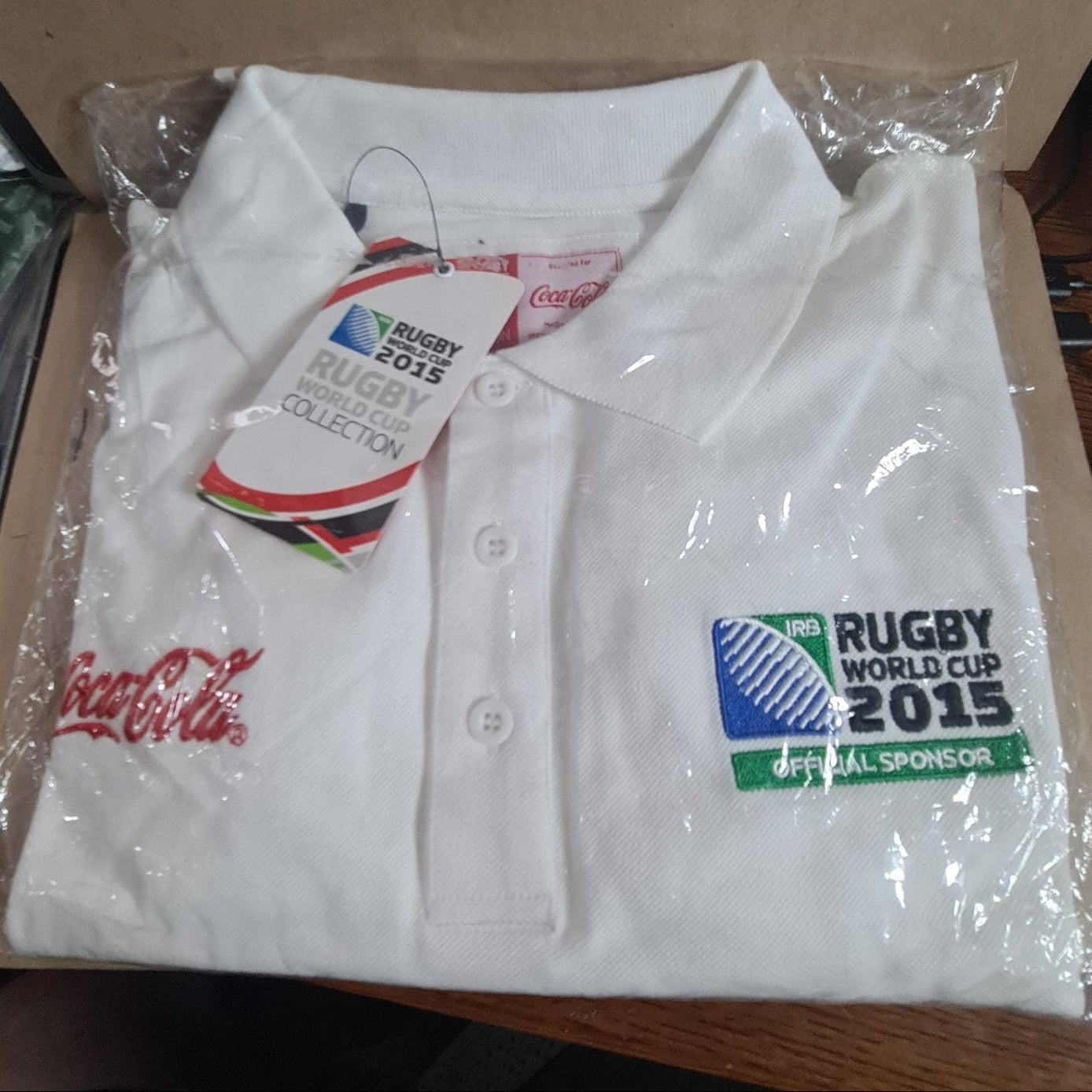2015 Rugby World cup unused in packet size Small Coca-Cola sponsored polo shirt white 