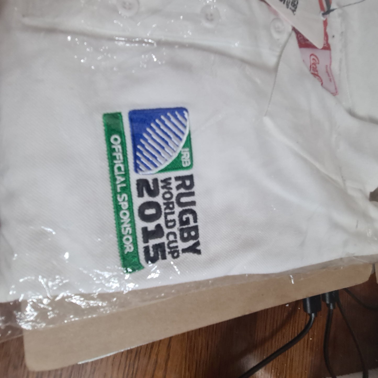 2015 Rugby World cup unused in packet size Small Coca-Cola sponsored polo shirt white